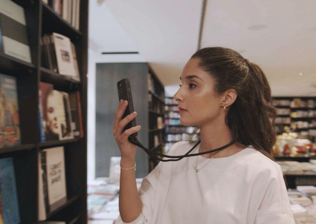 visually impaired women scanning books in a book store with dot go app